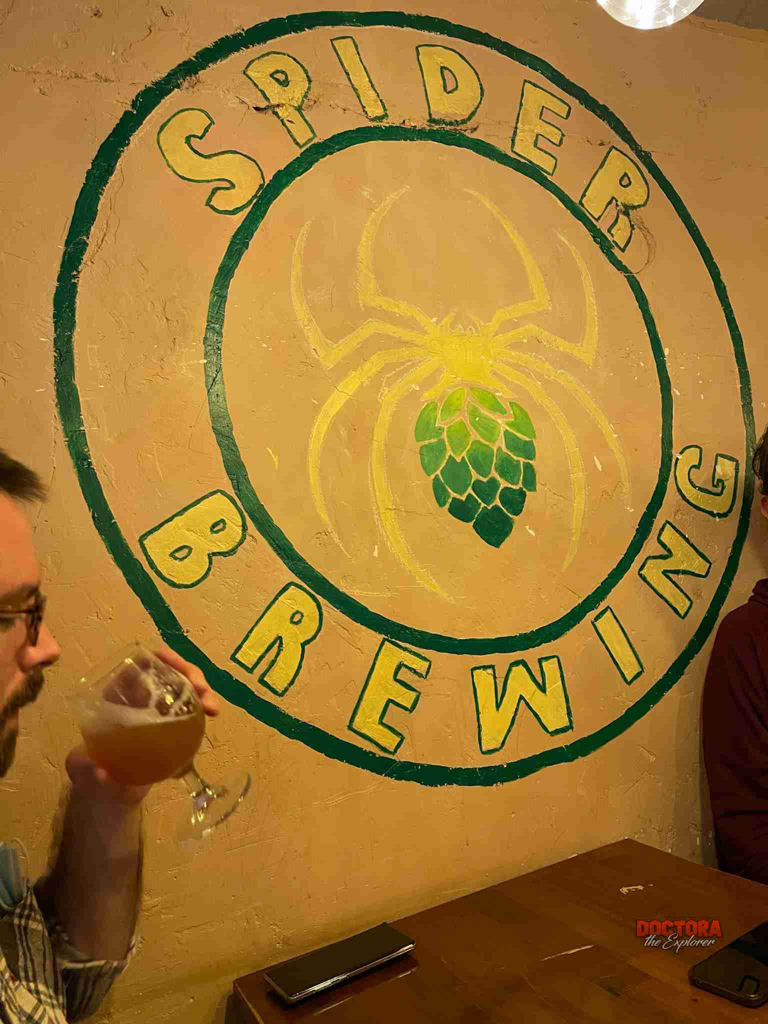 Spider Taproom Kitchen logo on wall